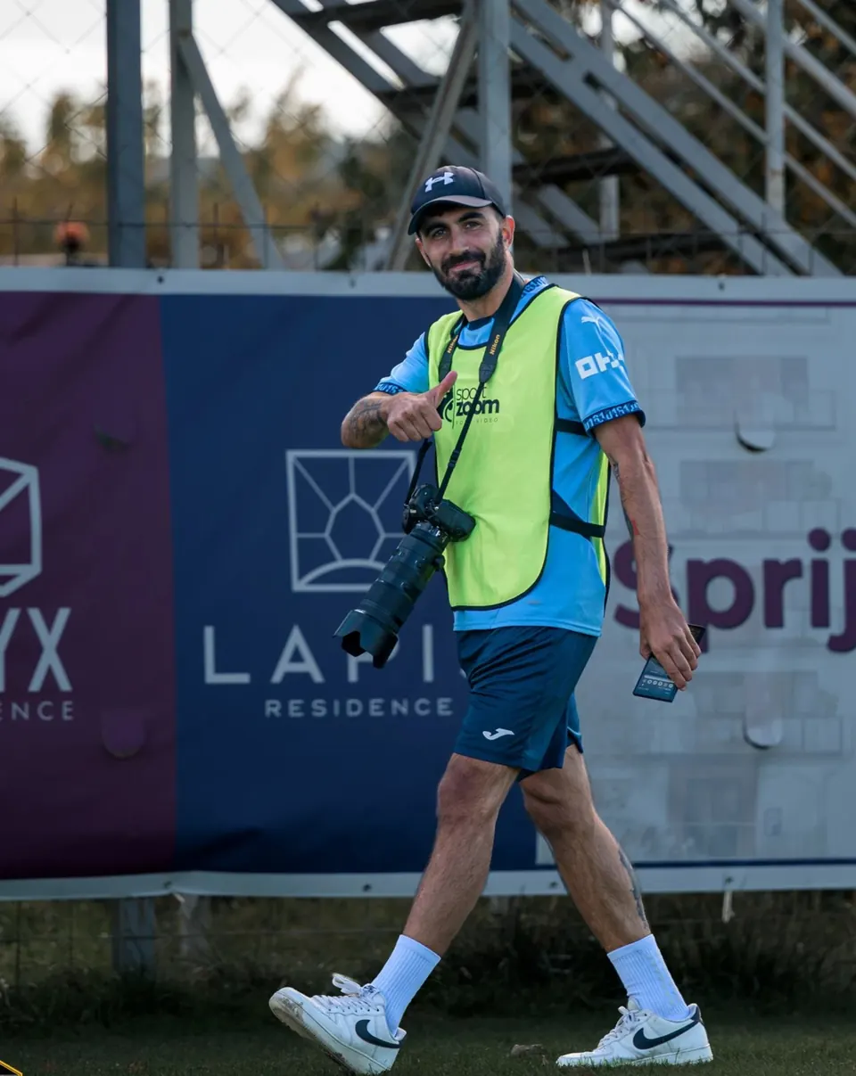 Silviu, the founder of Minkrop, pitchside with a camera around his neck